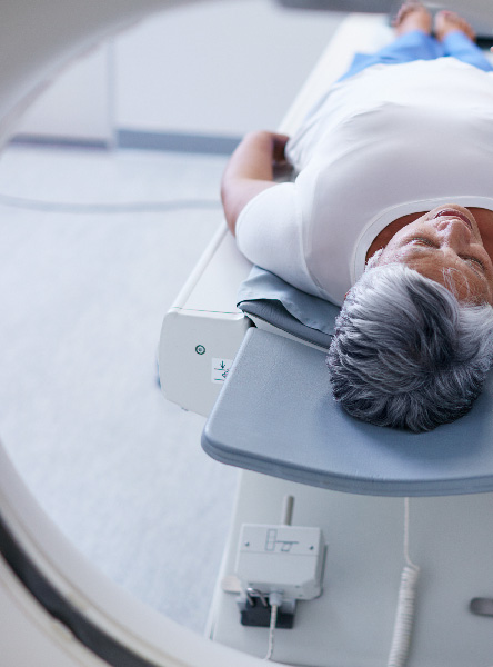 patient laying on an MRI machine bed