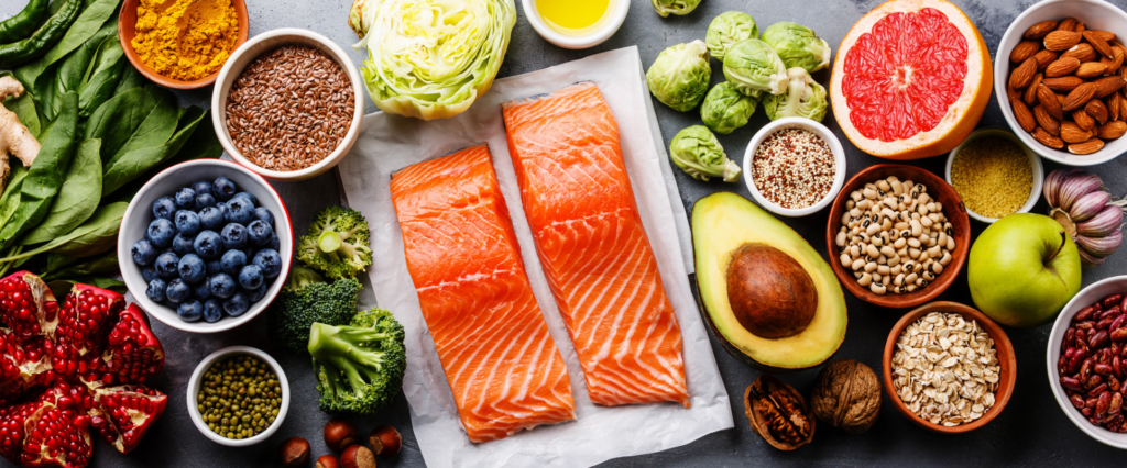 a variety of healthy foods, including blueberry's, salmon, avocado, Brussel sprouts, and almonds