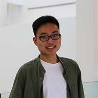 Matthew Chen, seen from the chest up, wearing a white t-shirt, green collared shirt, glasses, and short black hair