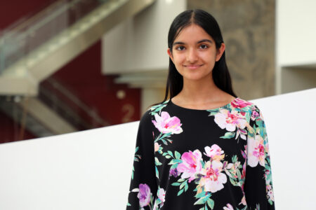 Shayna Sharma, wearing floral blouse with long black hair