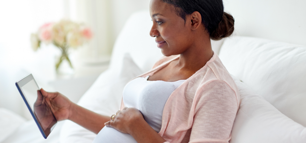 A pregnant woman on her iPad